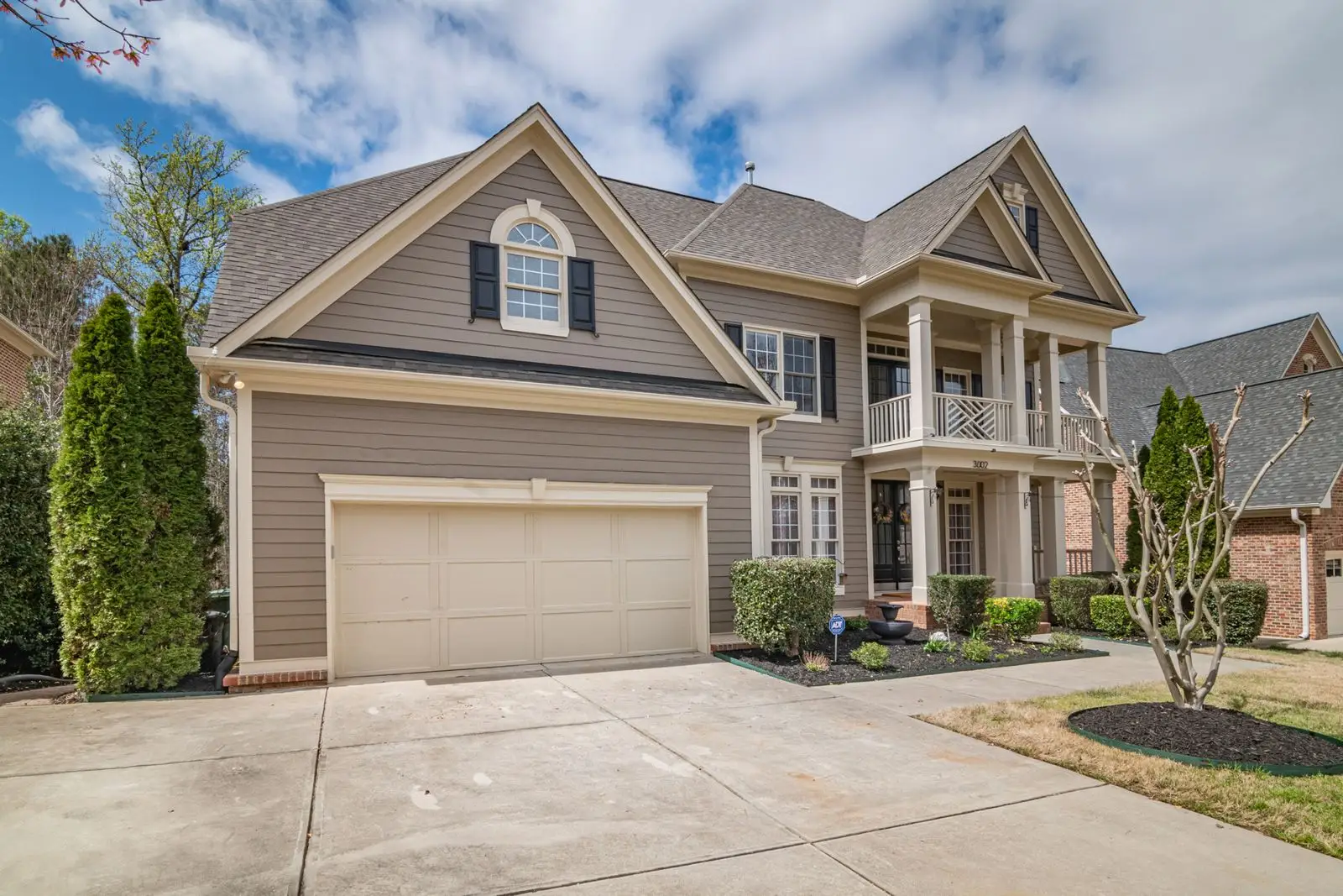 Colonial-style home with a raised-panel garage door