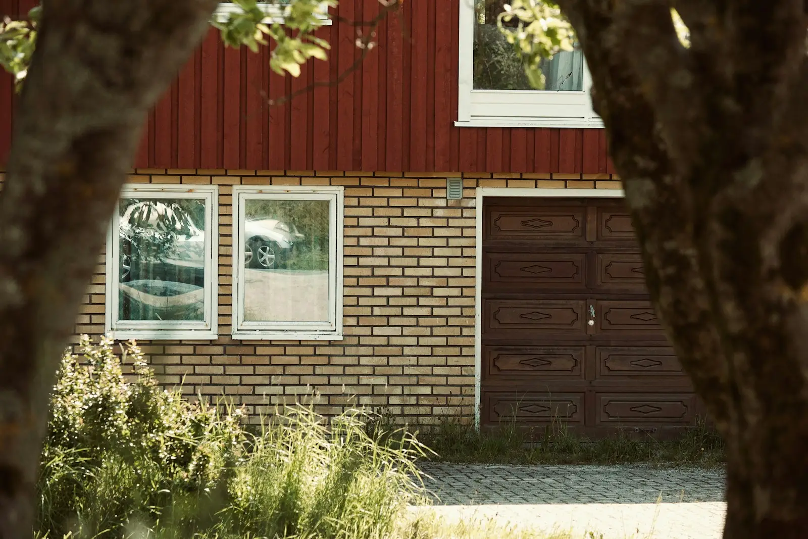 Brick home with a rich wooden garage door